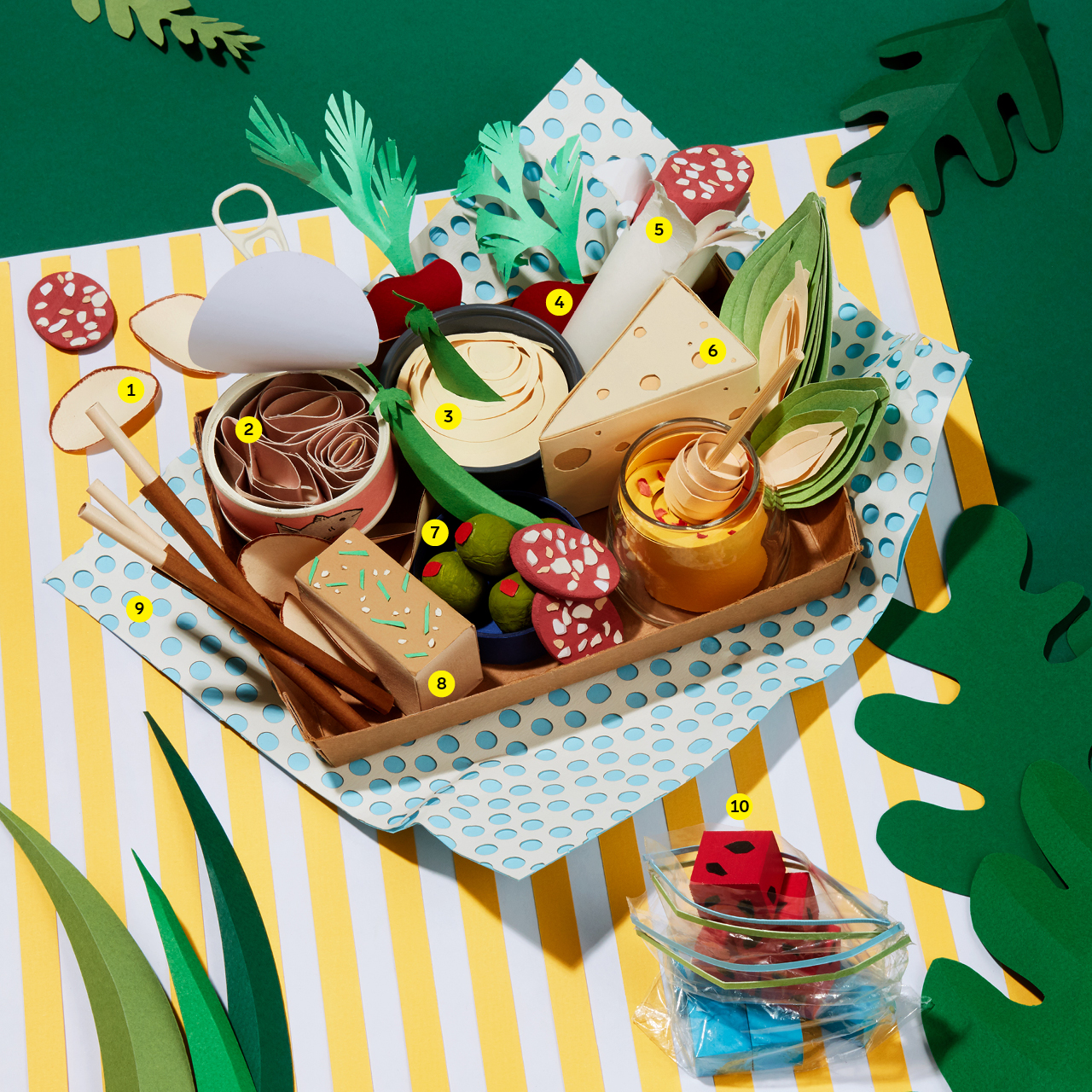 Paper picnic basket, decorated by assorted foods, treats, games