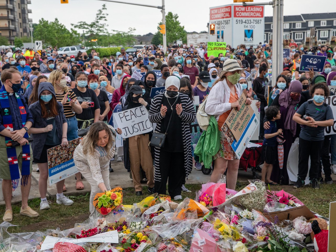 A photo of people at the scene where a Muslim family was killed in a vehicle attack in London, Ont. (Photo: Brett Gundlock/Anadolu Agency via Getty Images)