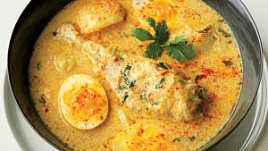 an image of chicken, potatoes and eggs in a coconut sauce (Kuku paka)