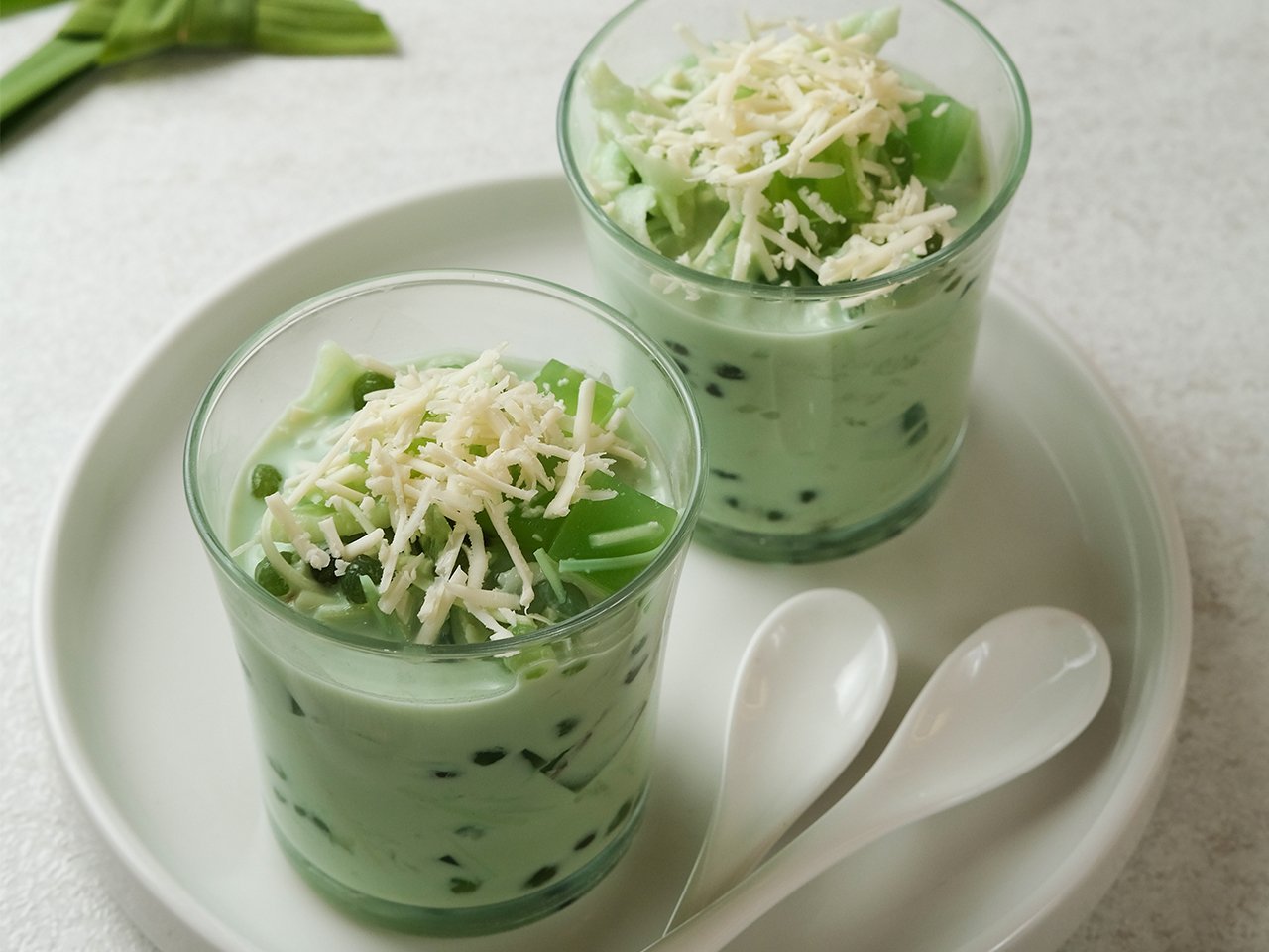 Buko pandan salad in two glasses on a plate