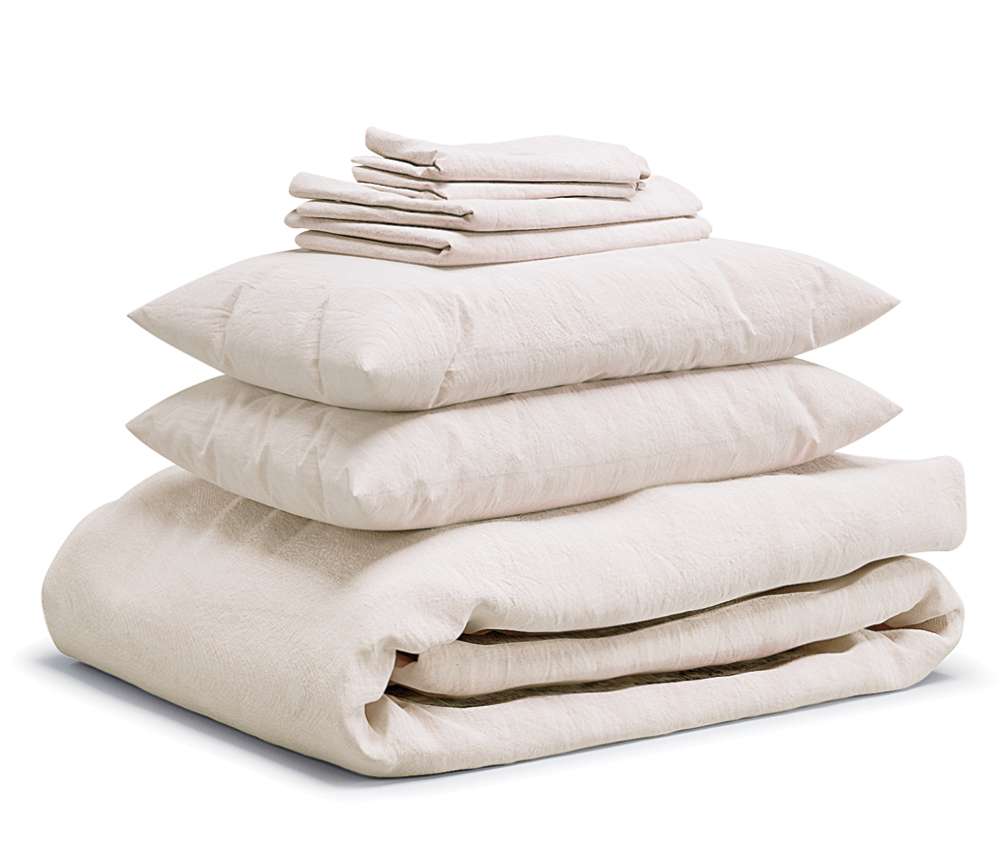 White Flax Home bed sheets stacked on top of each other
