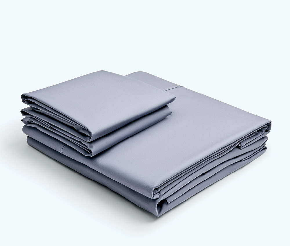 Grey Takasa bed sheets stacked on top of each other