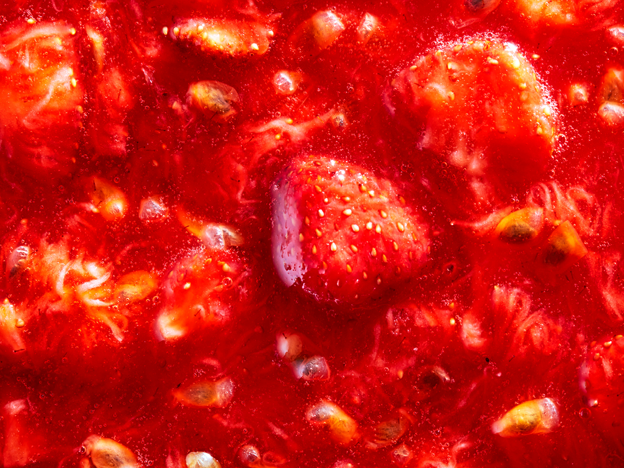 An extreme close-up photo of strawberry jam