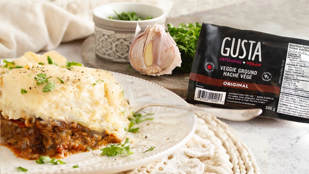 A package of GUSTA Veggie Ground sits next to a plate with veggie shepherd's pie on it.