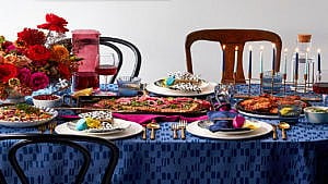 A dinner table set with various holiday foods