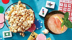 A bowl of popcorn and various items from table games