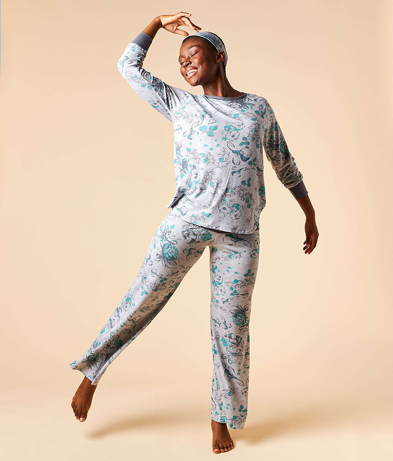 Model wears matching grey floral long sleeve pyjama set.