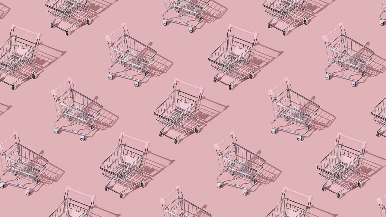 An illustration of empty supermarket trolleys tiled on a pink background