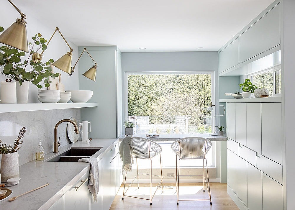 A kitchen with light shades of blue and green