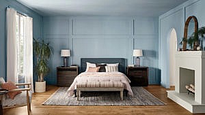 A modern bedroom painted blue for a round-up of trending paint colours for 2022.