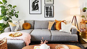 A living area with grey couch styled by a virtual interior designer