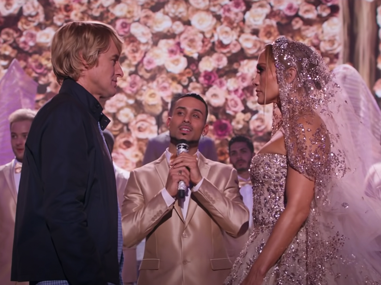 screengrab of Marry Me trailer with Jennifer Lopez and Owen Wilson getting married on stage