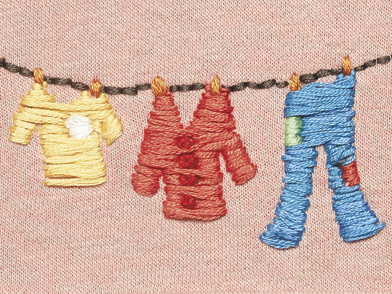 An embroidered illustration of three items of clothing hanging on a clothesline