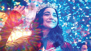 TV shows to watch for Asian Heritage Month: a photo from Ms. Marvel of a smiling girl dressed in a superhero suit and a tiara