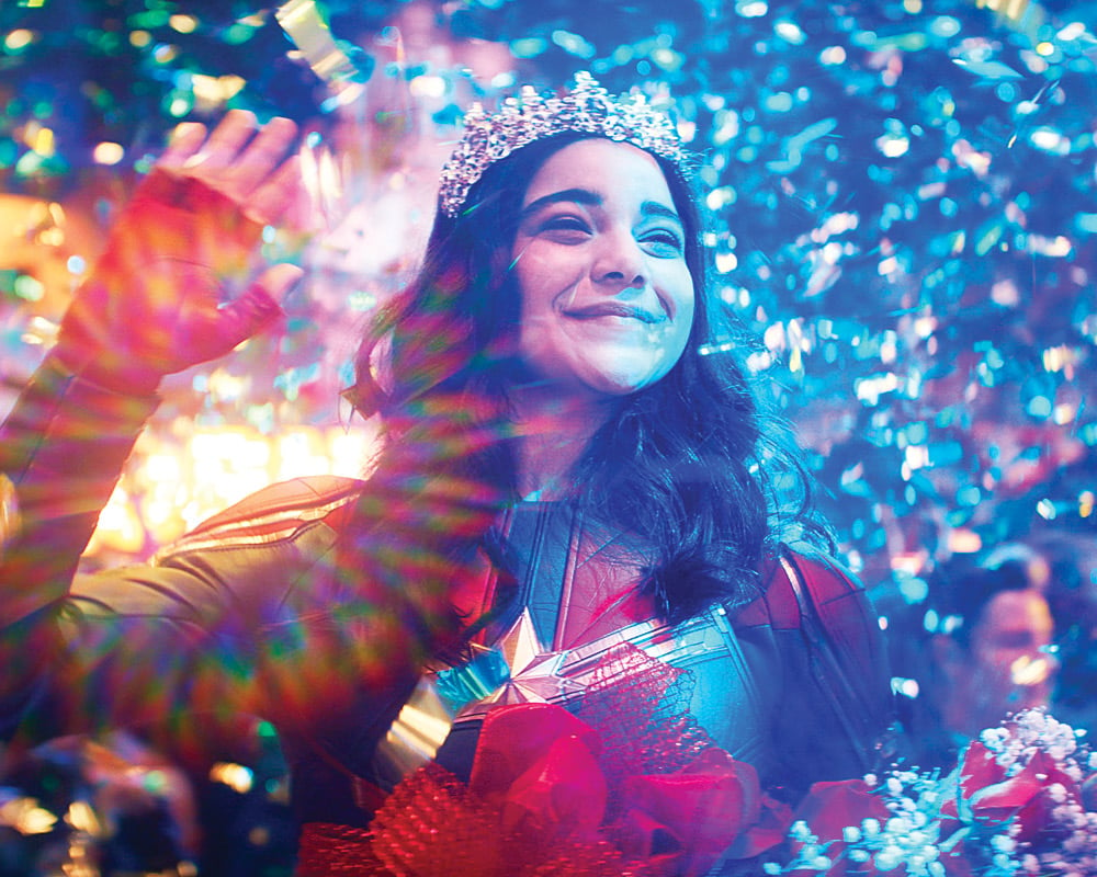 TV shows to watch for Asian Heritage Month: a photo from Ms. Marvel of a smiling girl dressed in a superhero suit and a tiara