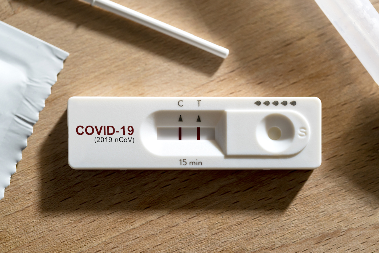 A close up of a positive COVID test result for a feature on COVID questions