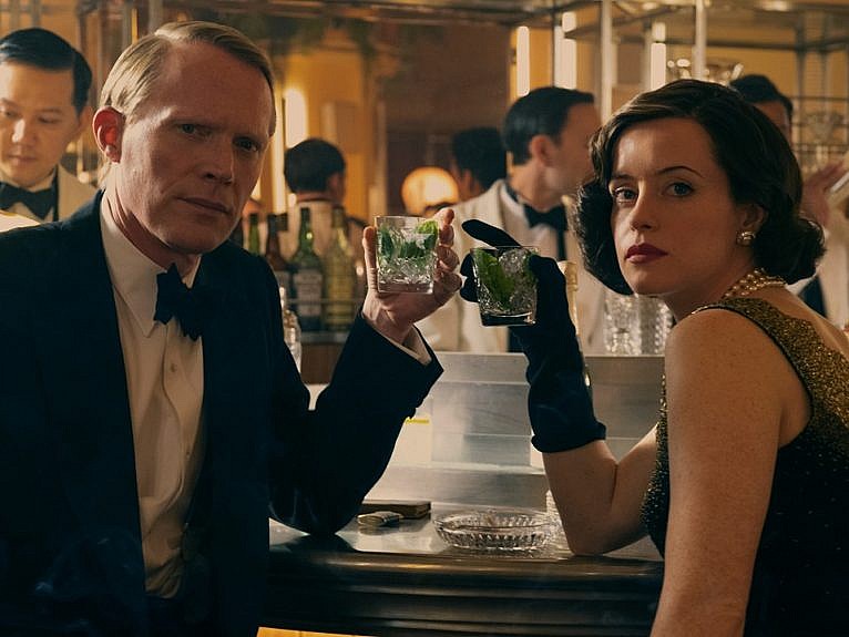 The best TV shows to watch in Spring 2022: A screenshot from A Very British Scandal of a man and woman having drinks at a dimly lit bar