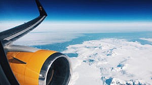The author’s view from the window seat, flying over Greenland.(Photo: Kat Tancock)