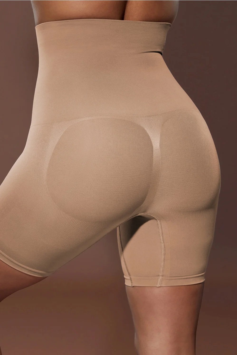 A model wearing the Nearly Naked Shaping Ultra High Waist Short from Yitty, Lizzo's shapewear line