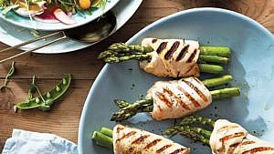 grilled asparagus-stuffed chicken on a blue plate