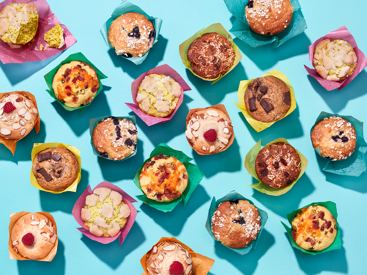 multiple arrangements of muffins with various coloured wrapping paper on a blue background