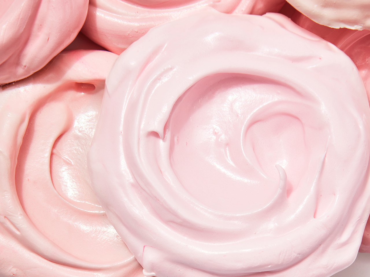 A light pink circle swirl on top of other pink swirls.