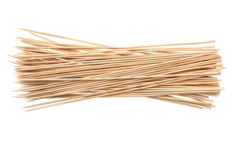 a pile of bamboo barbecue skewers on a white background