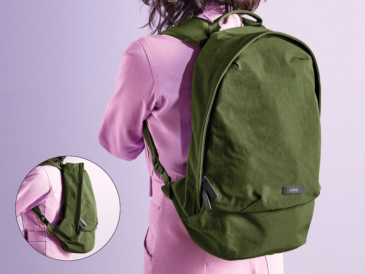 A photo of the back of a woman in a lilac jumpsuit wearing a khaki green backpack