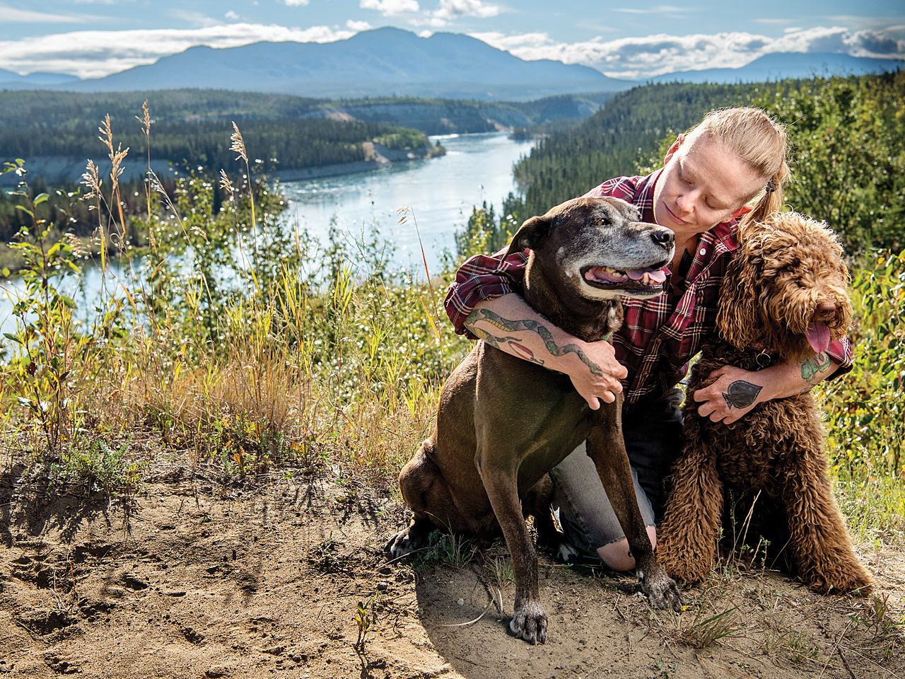 Lori Fox hugs their dogs, Herman (left) and Audrey, in their home of Whitehorse, Yukon.