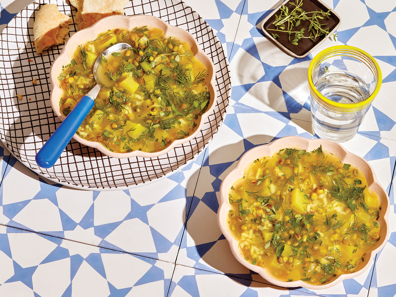 Two bowls of Persian-style mung bean soup served on a printed tile counter