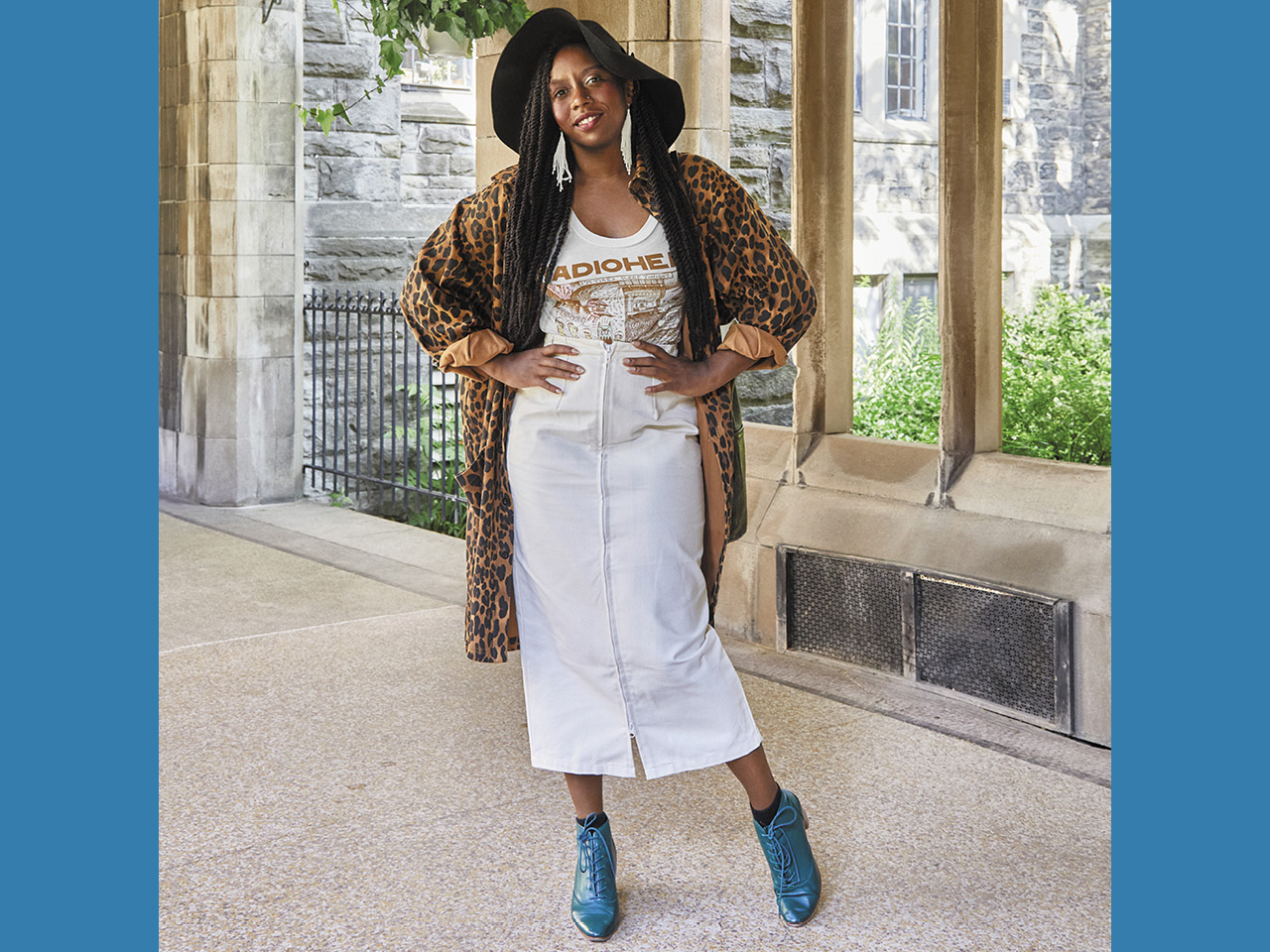 Assistant Professor Hadiya Roderique pictured in her favourite outfit of white midi skirt, Radiohead tee and leopard-print chore coat.