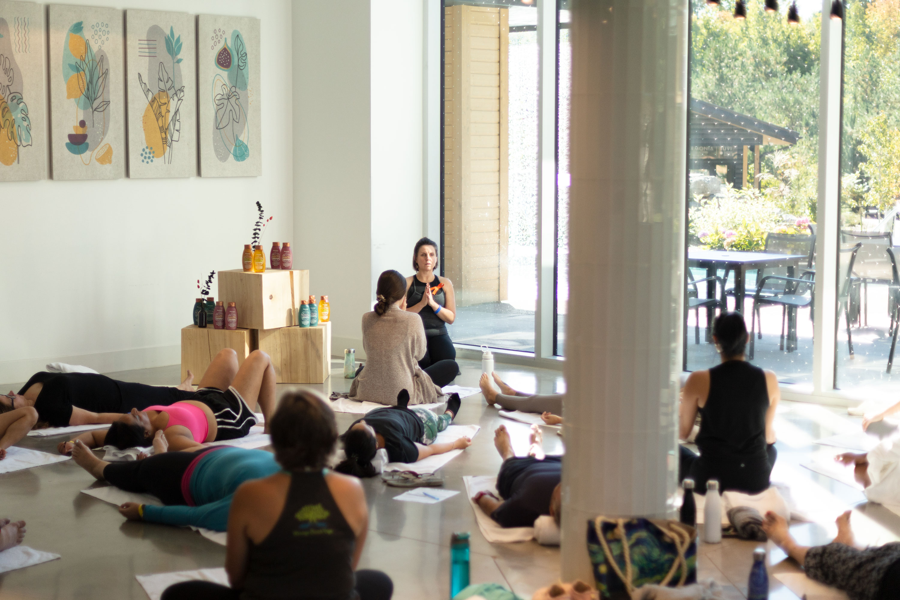 A photo of a yoga instructor leading a yoga class of women