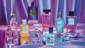A collection of the best perfumes for women of 2022 photographed against a purple iridescent background.