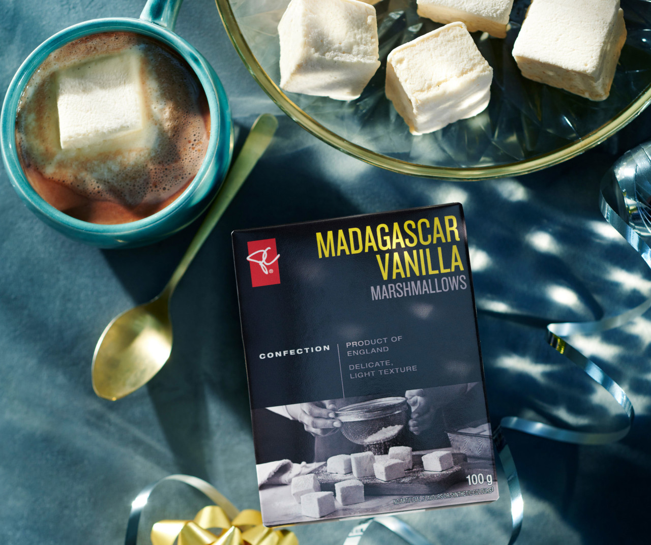 Hot cocoa with marshmellows next to box of PC Black Label Madagascar Vanilla Marshmallows
