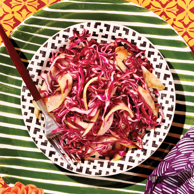 A plate of slaw with a wooden fork
