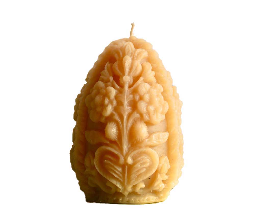 A yellow Fabergé egg-shaped beeswax candle from Barletta Beeswax.