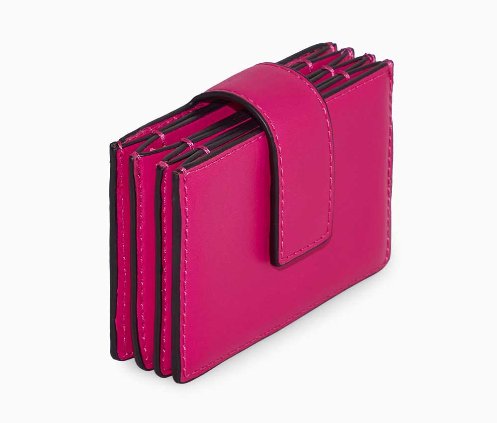 A folded pink leather card holder from COS.