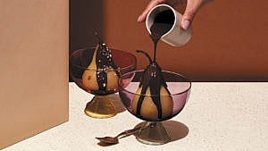 Chili-chocolate sourced being poured over Tequila-poached pears