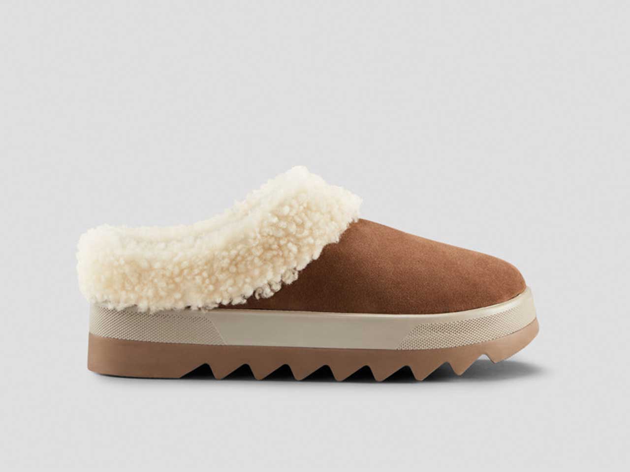 A slippers with lug soles and a shearling trim from Cougar shoes.