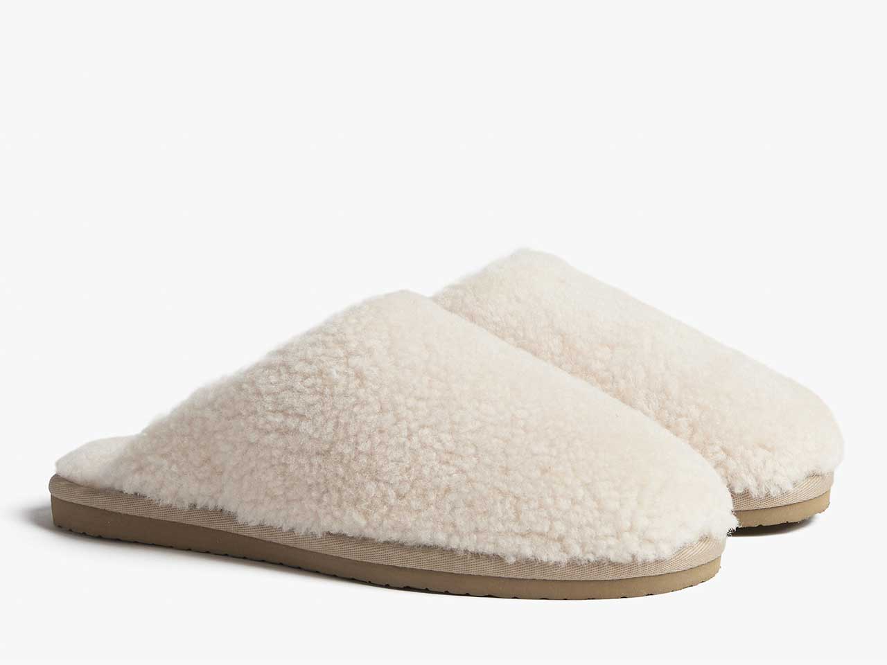 A pair of white shearling mules from Parachute.