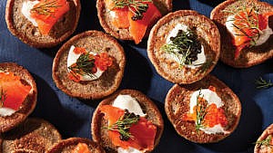 Seafood tower recipes: buckwheat blinis garnished with smoked salmon, dill, salmon roe, and sour cream