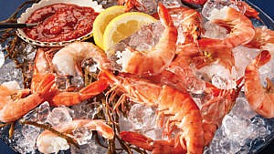 Seafood tower recipes: succulent shrimp cocktail served on ice with caesar-style cocktail sauce
